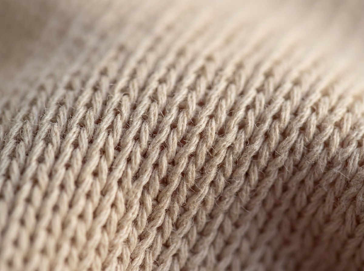 Extreme macro of ecru knitted cotton loops